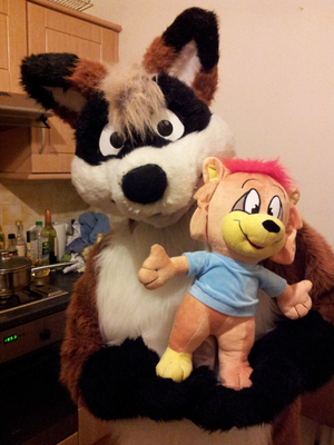  Here's a picture of the finished Roarey plush that arrived this afternoon, held by my other half flintgf in his fursuit, so you can get an idea of scale. For those of you who have ordered one, they'll be getting shipped out for you soon. But anyway, here he is XP.